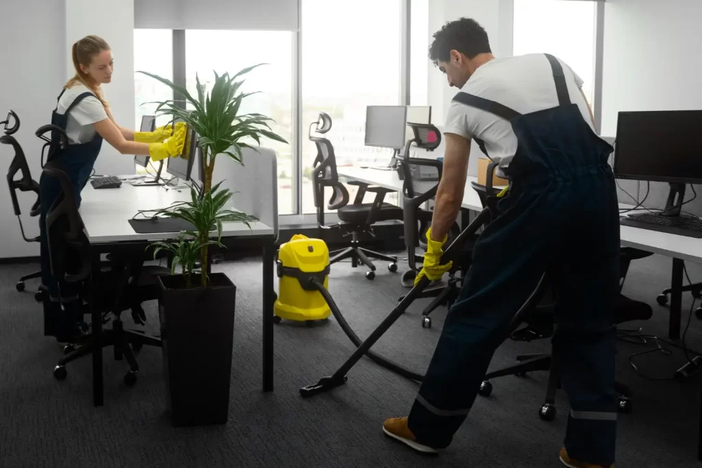 A team of cleaners in an office to show the commercial cleaning services that RSM Property Solutions can give to Oxfordshire, Wiltshire, and Gloucestershire.