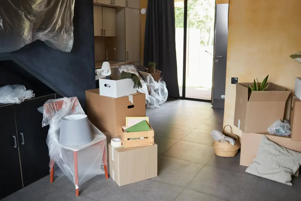 A busy room in a house with boxes that need removing. This shows the property clearance services that RSM Property Solutions provides in Oxfordshire, Wiltshire, and Gloucestershire.