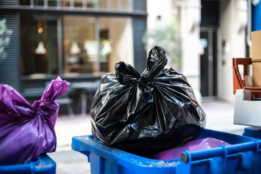 An image of a bin with refuse bags on top of it to show the waste removal services that RSM Property Solutions provides in Oxfordshire, Wiltshire and Gloucestershire.